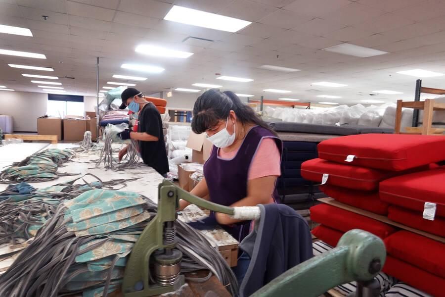 Workers at an outdoor furniture manufacturer in Illinois make personal protective equipment. For some workers, the demand for their labor has skyrocketed during the pandemic and for others the opposite has happened. (Photo: Scott Olson/Getty Images)