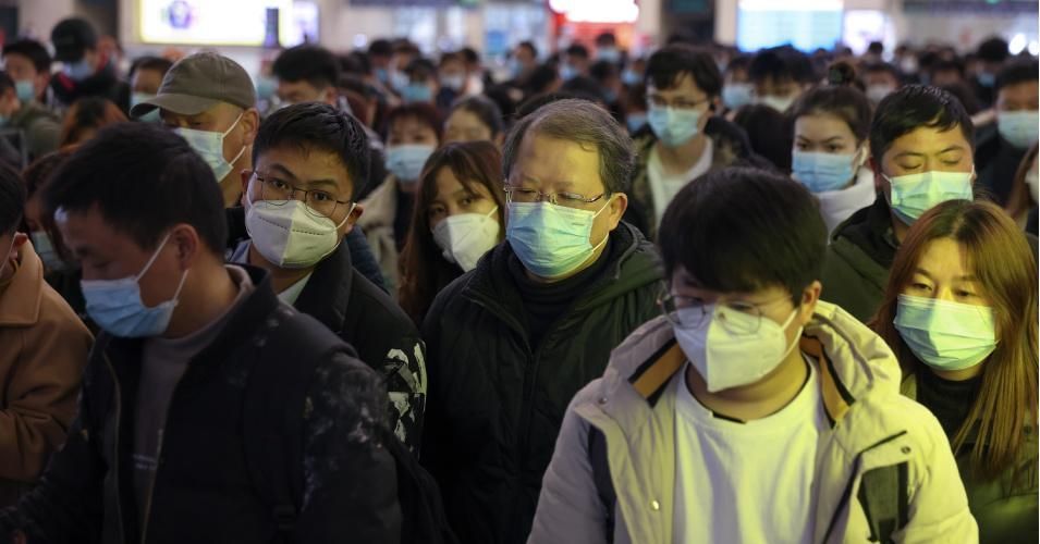 Chinese travelers wear protective masks while boarding a train before the annual Spring Festival at Wuhan railway station on January 29, 2021. (Photo: Lintao Zhang/Getty Images)
