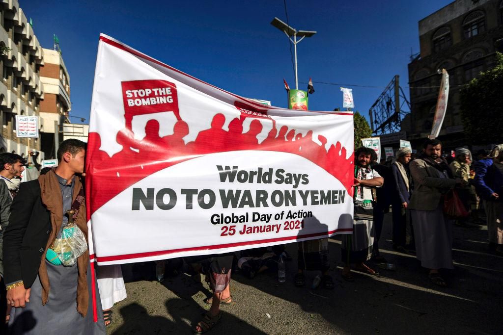 Supporters of Yemen's Huthi rebels march with banners during a rally denouncing the United States and the outgoing Trump administration's decision to apply the "terrorist" designation to the Iran-backed movement, in the Huthi-held capital Sanaa on January 25, 2021. (Photo: MOHAMMED HUWAIS/AFP via Getty Images)