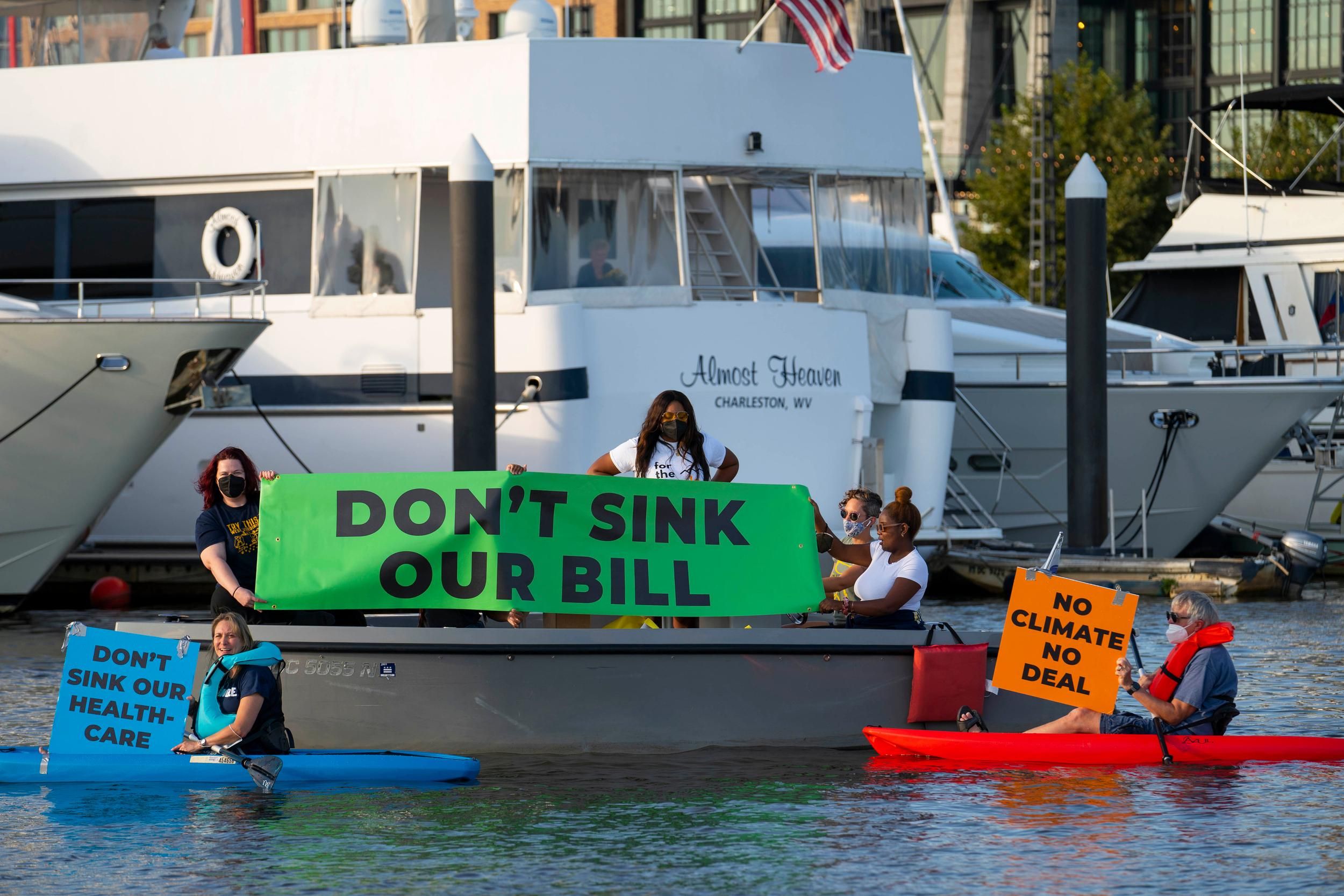 Activists near Sen. Manchin's houseboat hold 'Don't sink our bill' sign