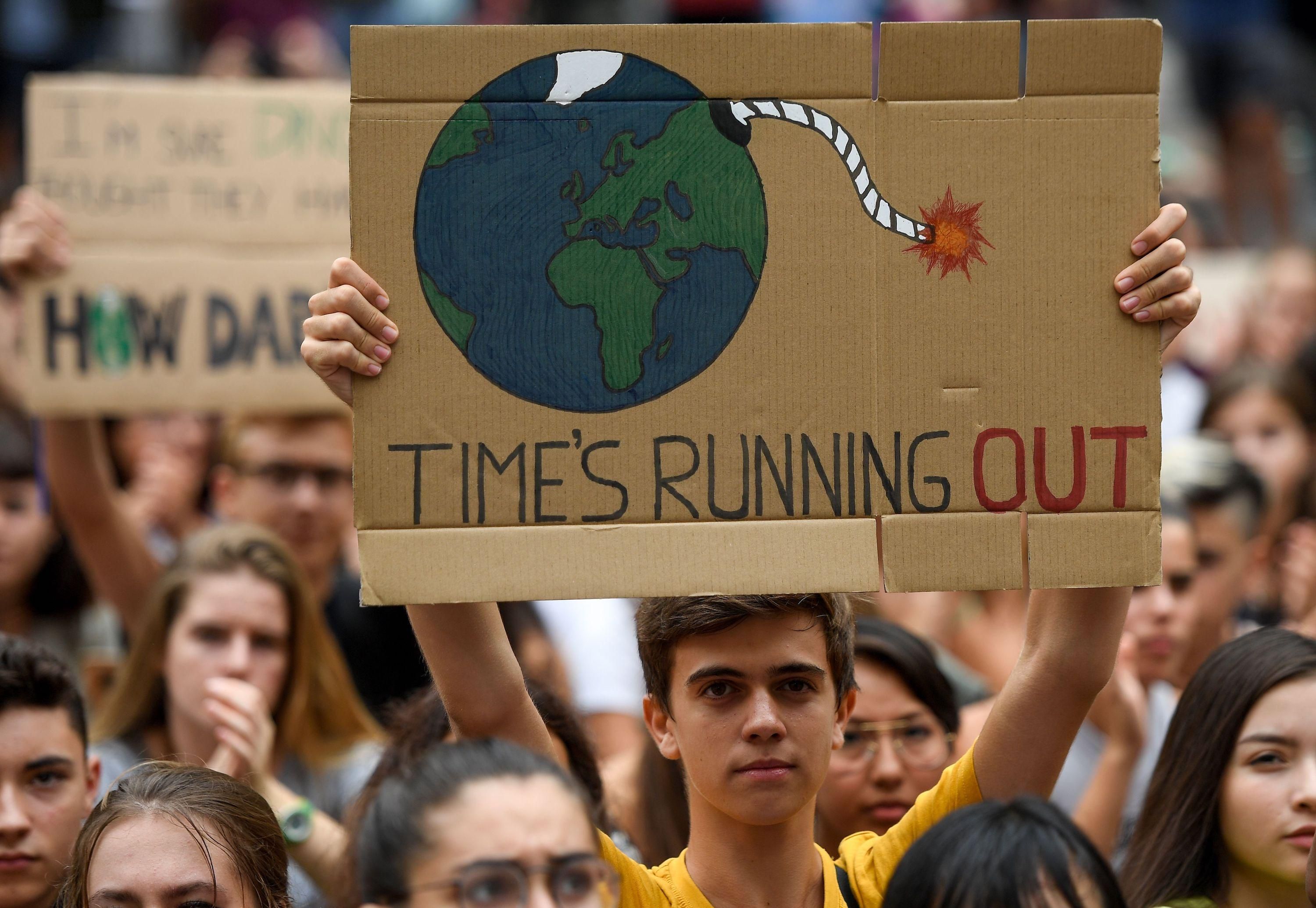 Placard reads: Time's running out