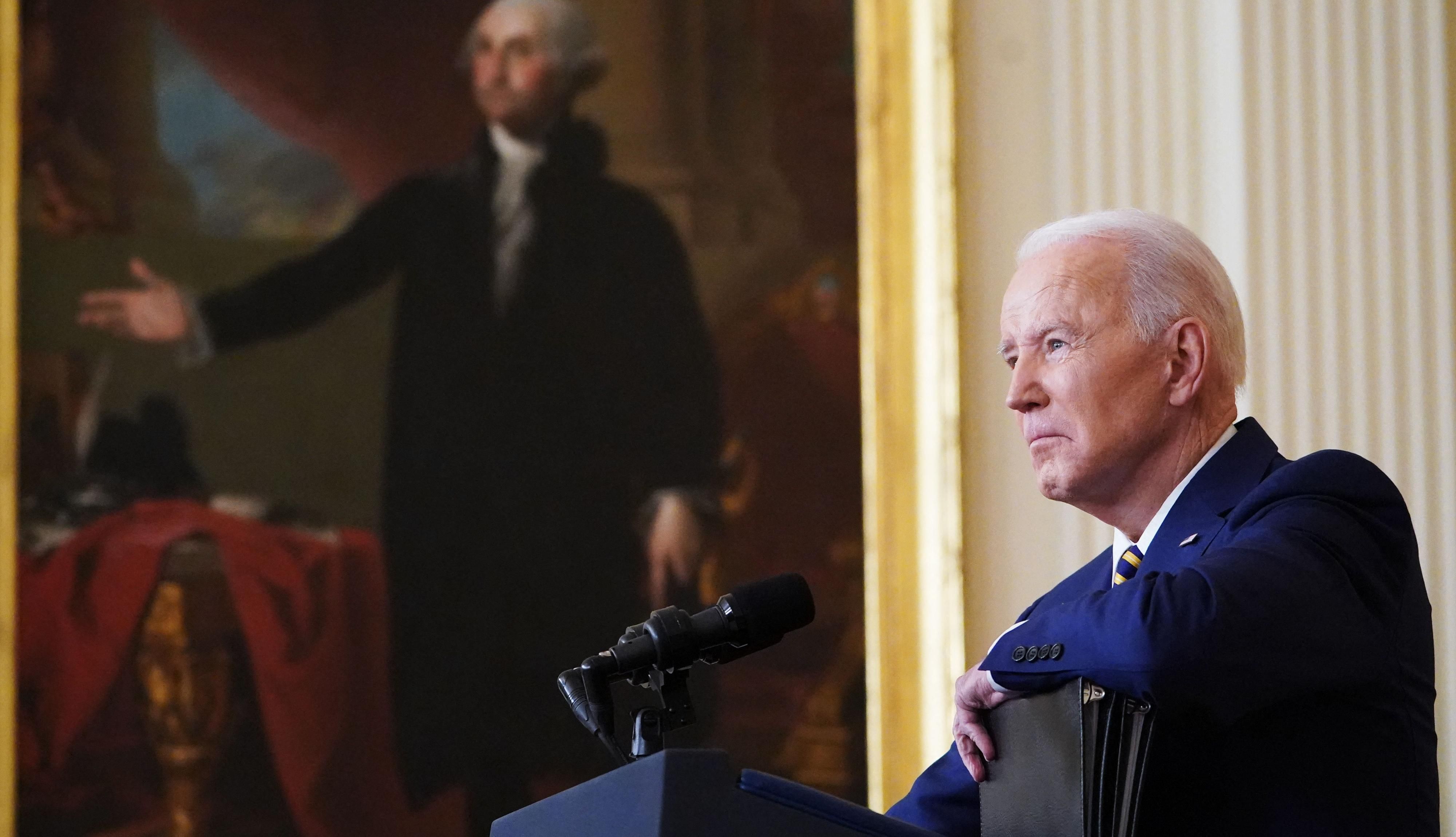 U.S. President Joe Biden listens to a question from a reporter during a press conference
