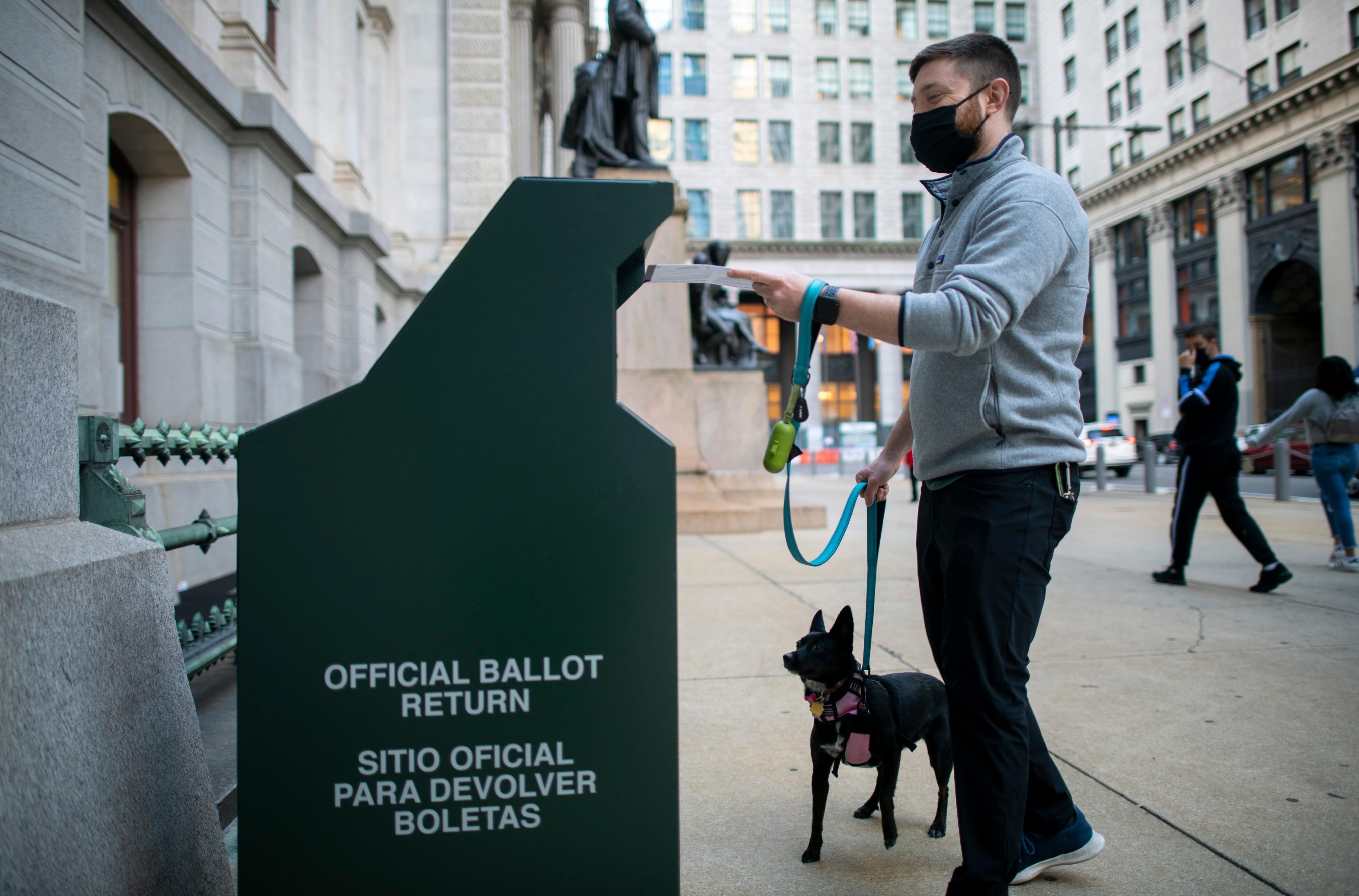 A voter mails in a ballot