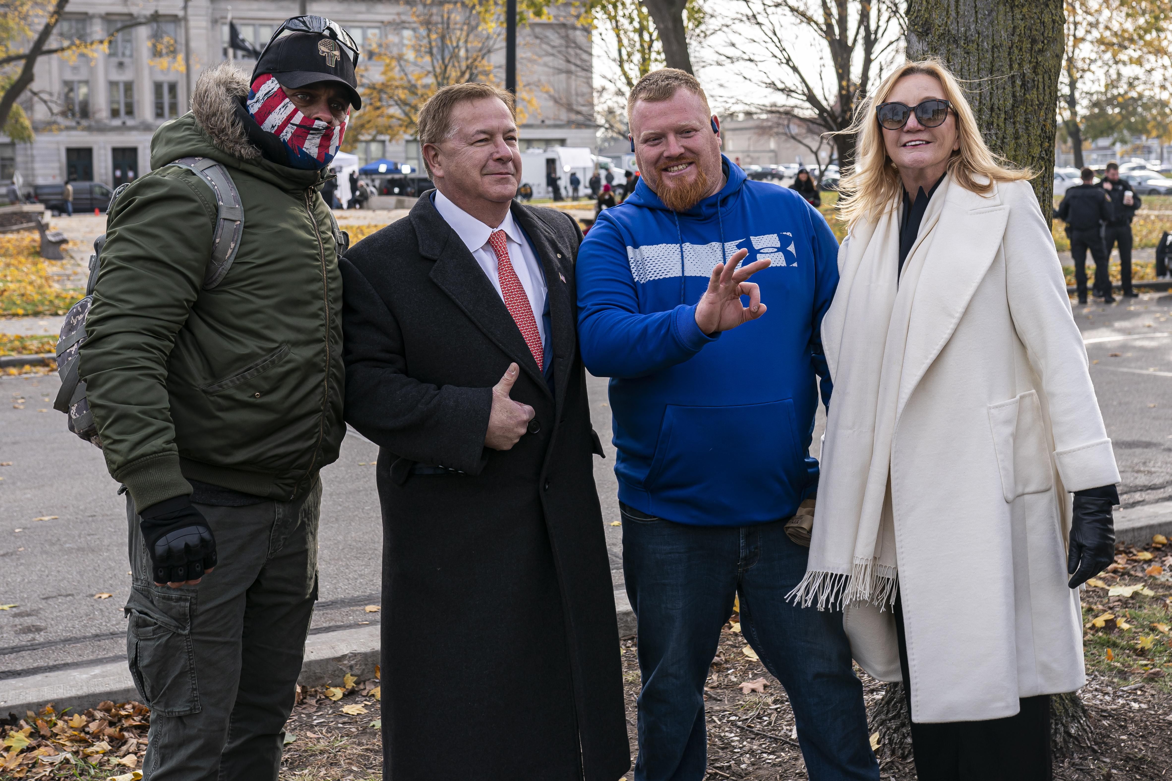 Mark McCloskey, center left, a Republican candidate for U.S. Senate in Missouri who first garnered attention in June 2020 after pointing guns at Black Lives Matter protesters outside his house in a gated community in St. Louis, poses with supporters of Kyle Rittenhouse and his wife Patricia McCloskey in front of the Kenosha County Courthouse while the jury deliberates the Rittenhouse trial on November 16, 2021 in Kenosha, Wisconsin.