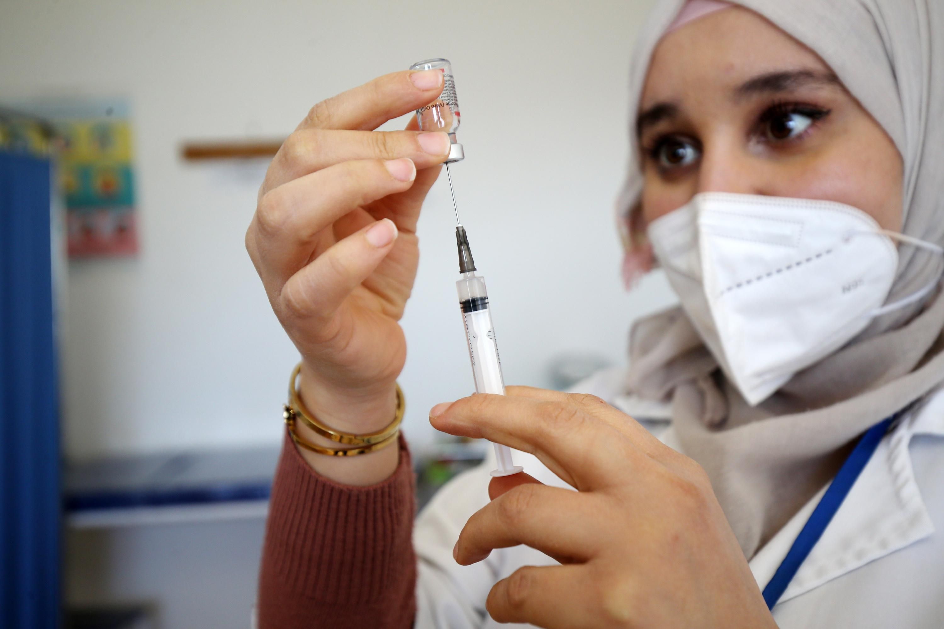 A health worker prepares a coronavirus vaccine dose