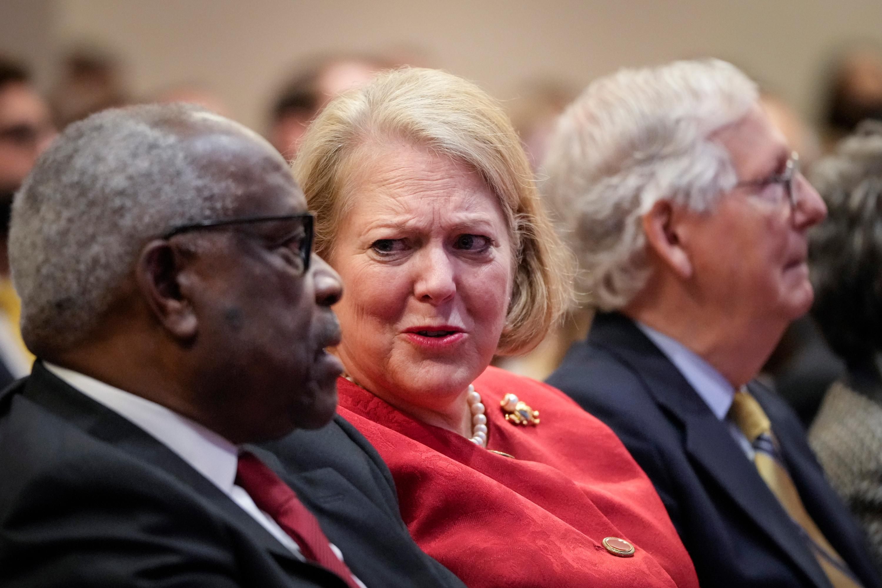 Supreme Court Justice Clarence Thomas sits with his wife Virginia Thomas