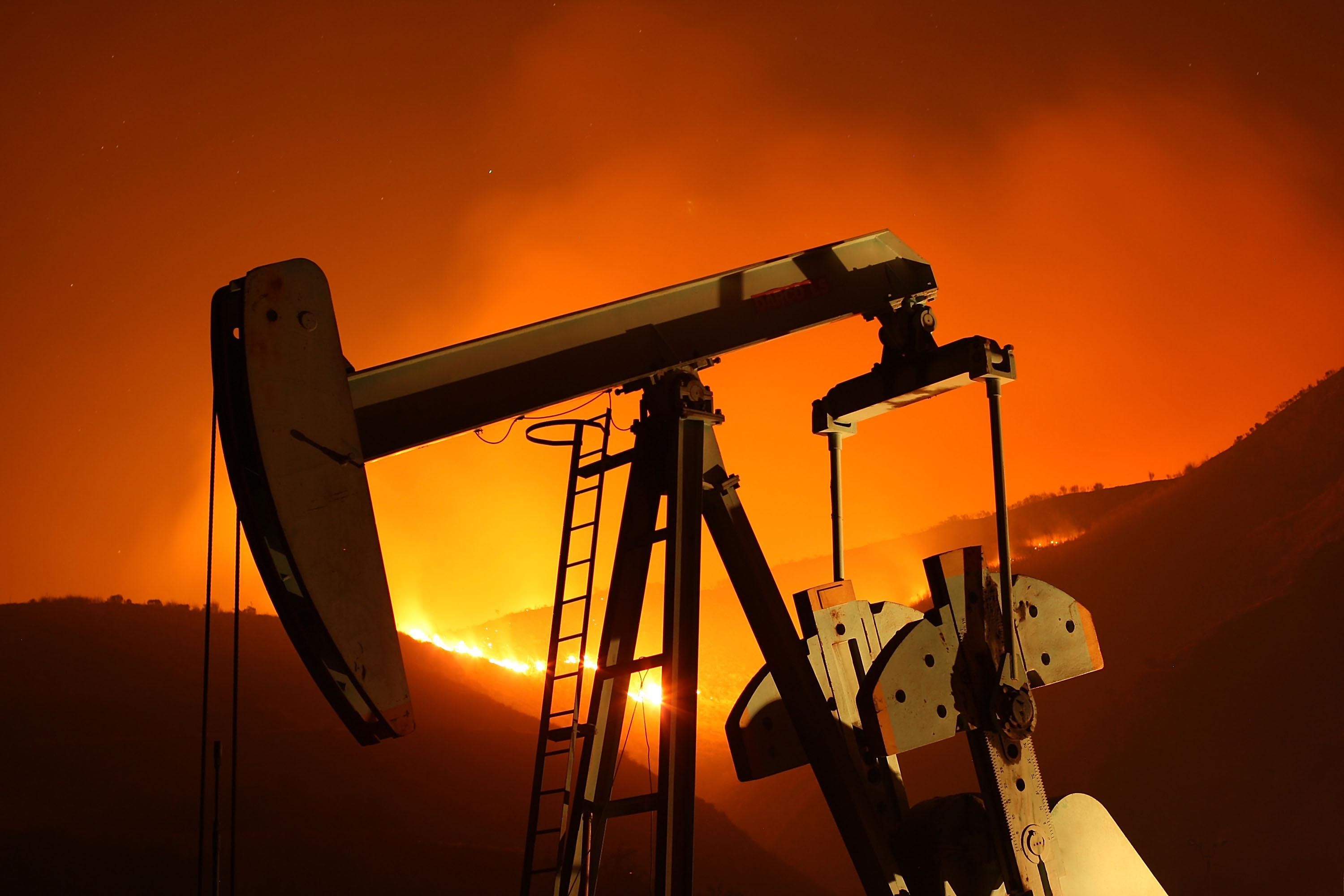 A fire burns near an oil well in California