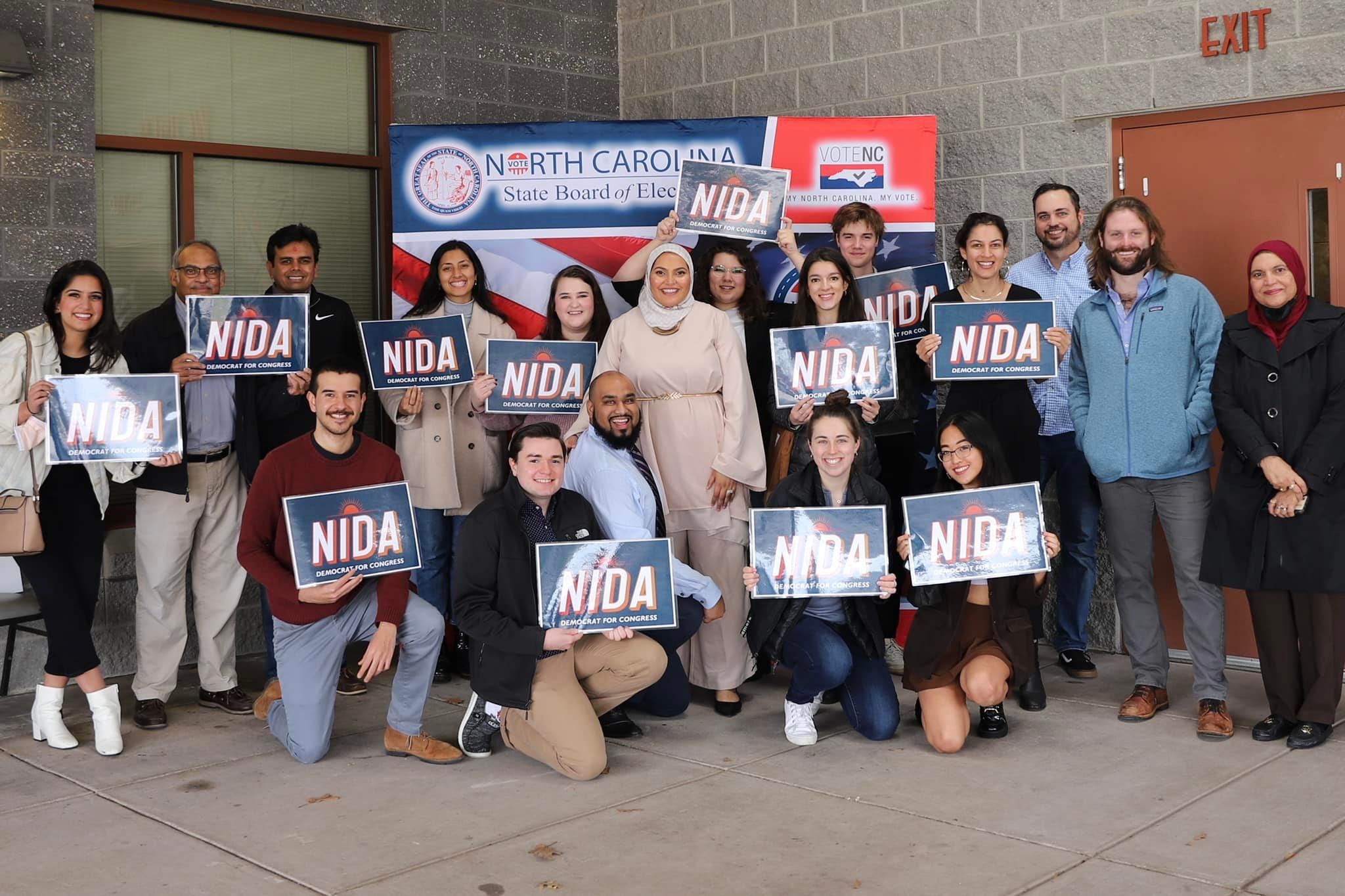 Durham County Commissioner Nida Allam, a Democratic candidate for North Carolina's 4th Congressional District, stands with campaign volunteers on February 25, 2022. 