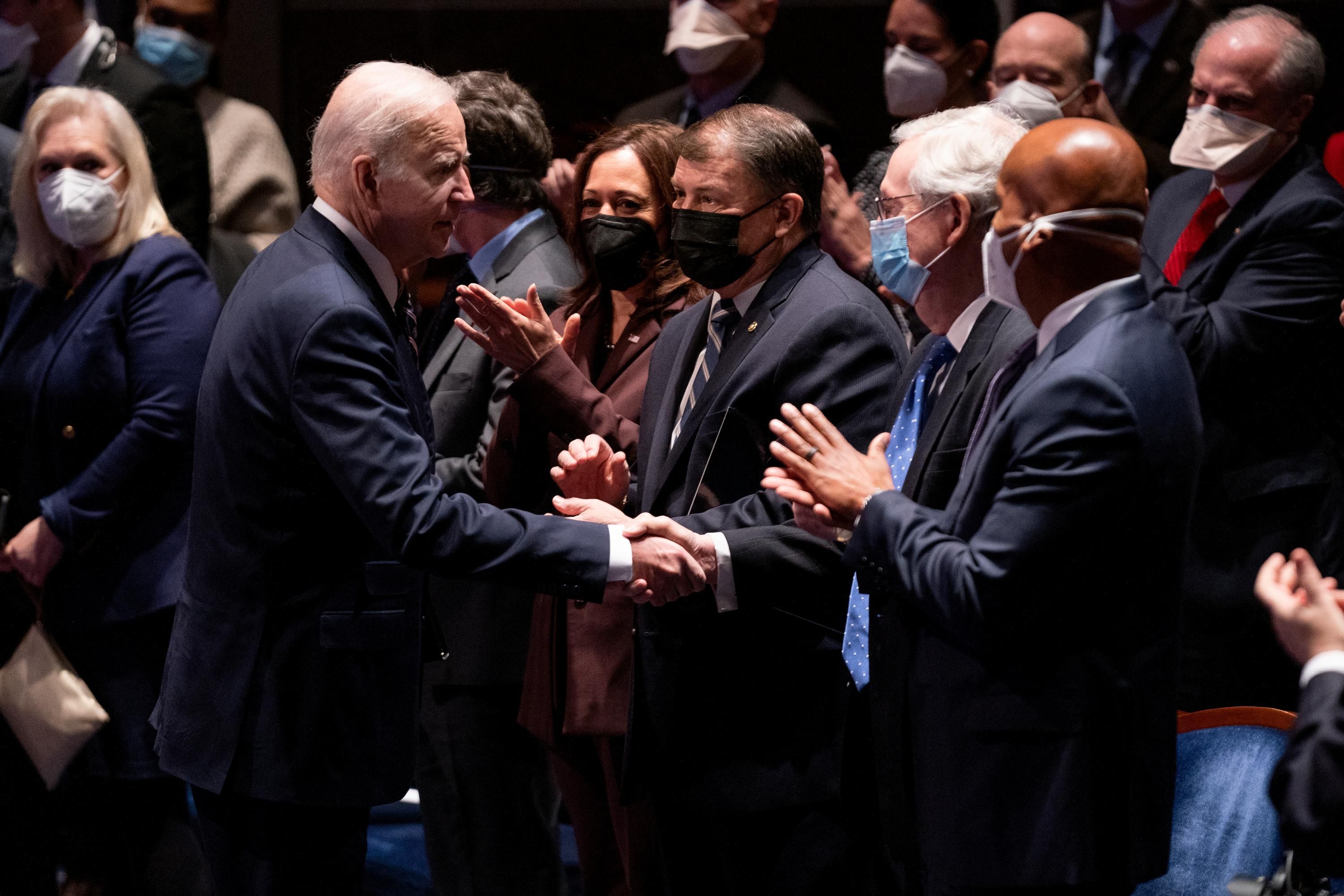 President Joe Biden shakes hands with Republican Senate Minority Leader Mitch McConnell