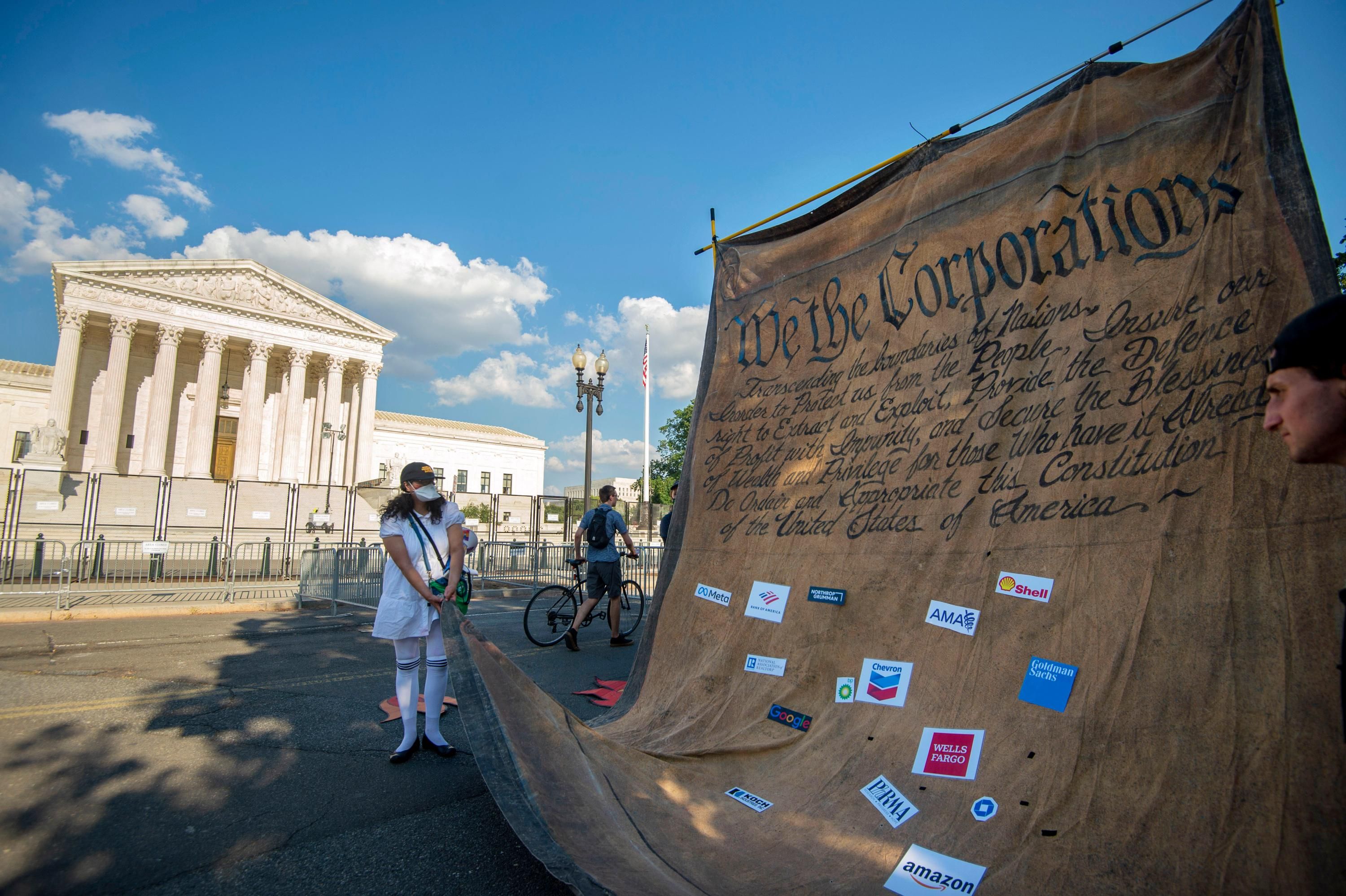 Demonstrators hold a mock Constitution outside the U.S. Supreme Court