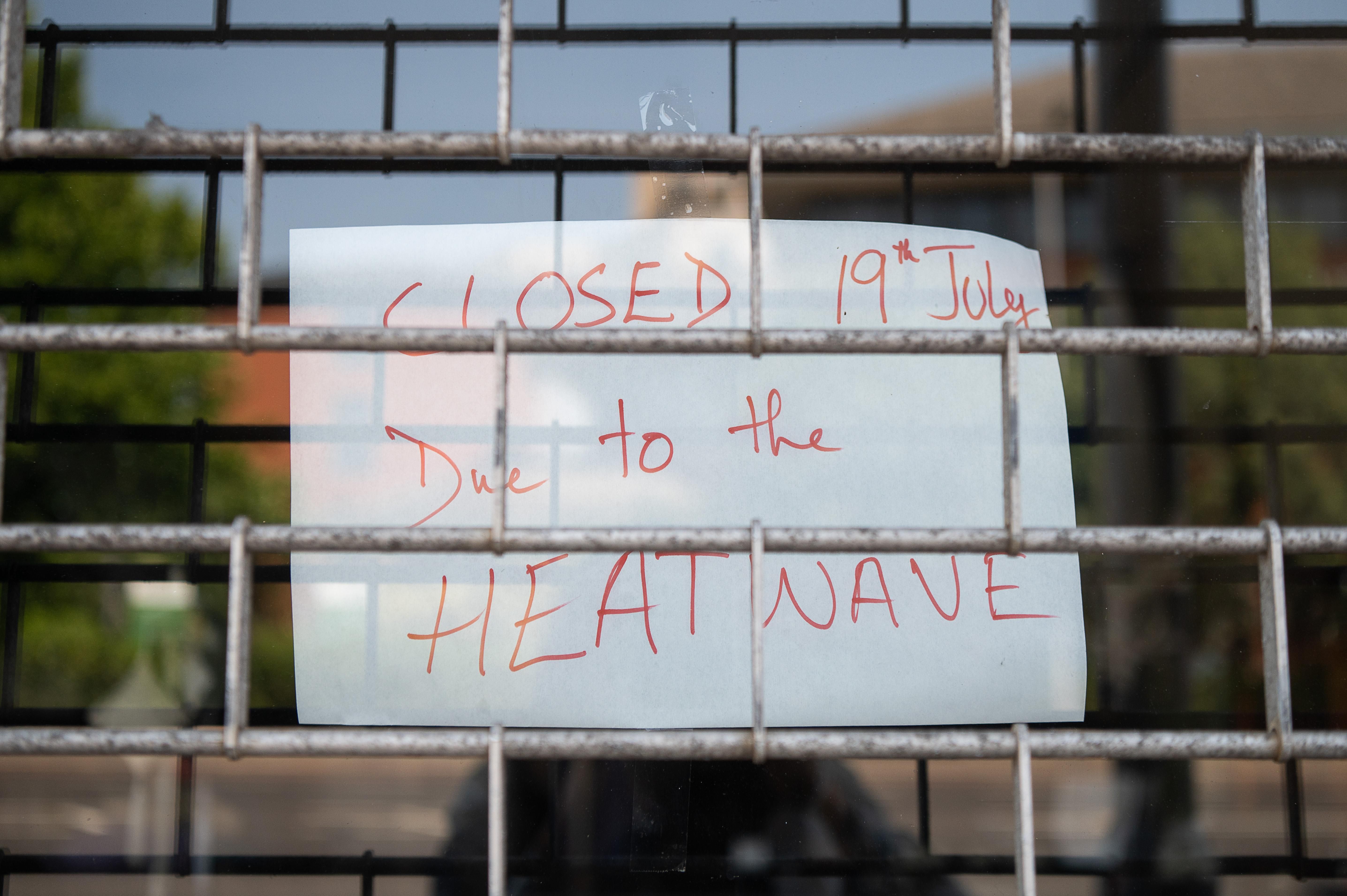 A sign indicating that a store is closed due to an ongoing heatwave is seen in London on July 19, 2022.