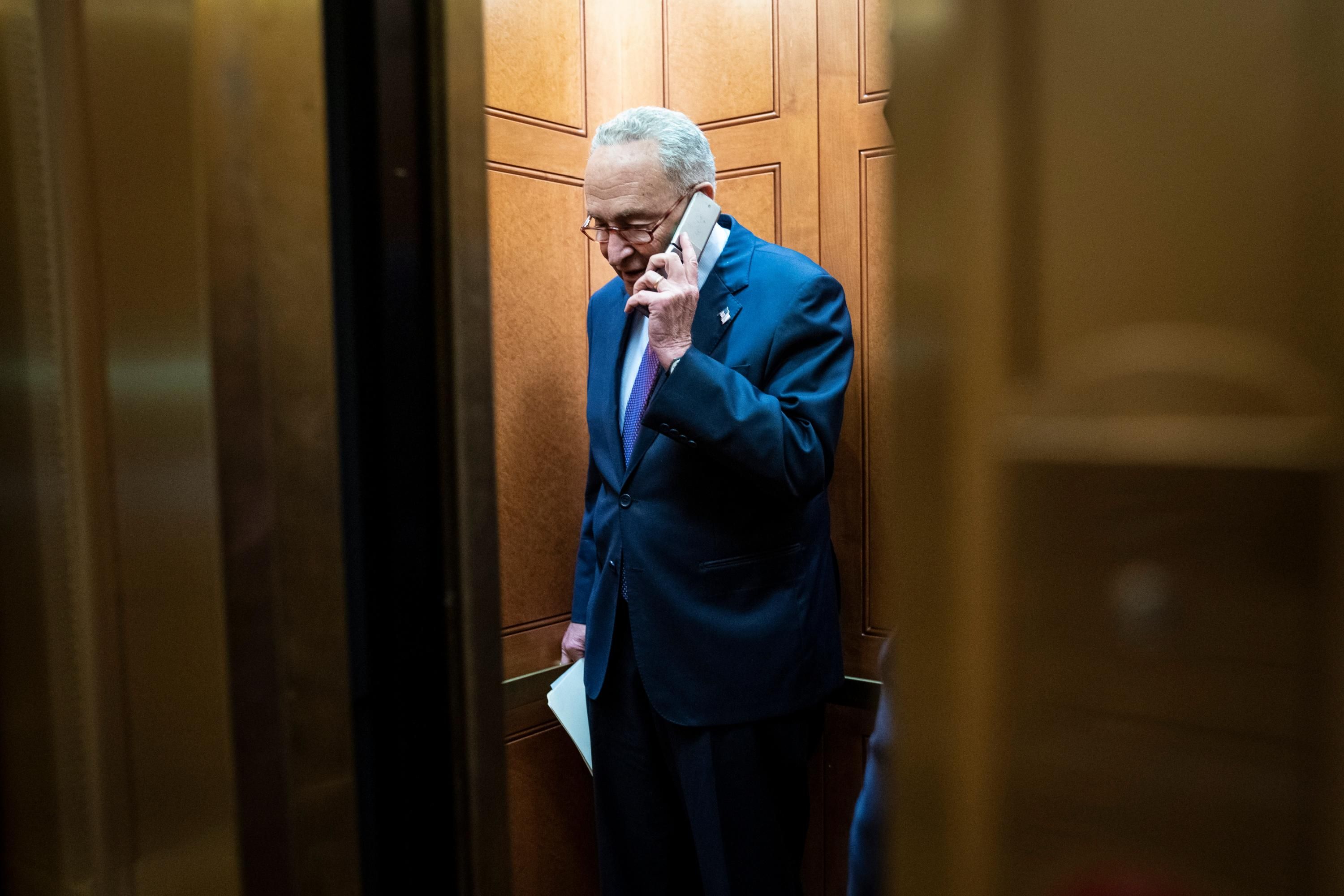 Senate Majority Leader Chuck Schumer talks on the phone.