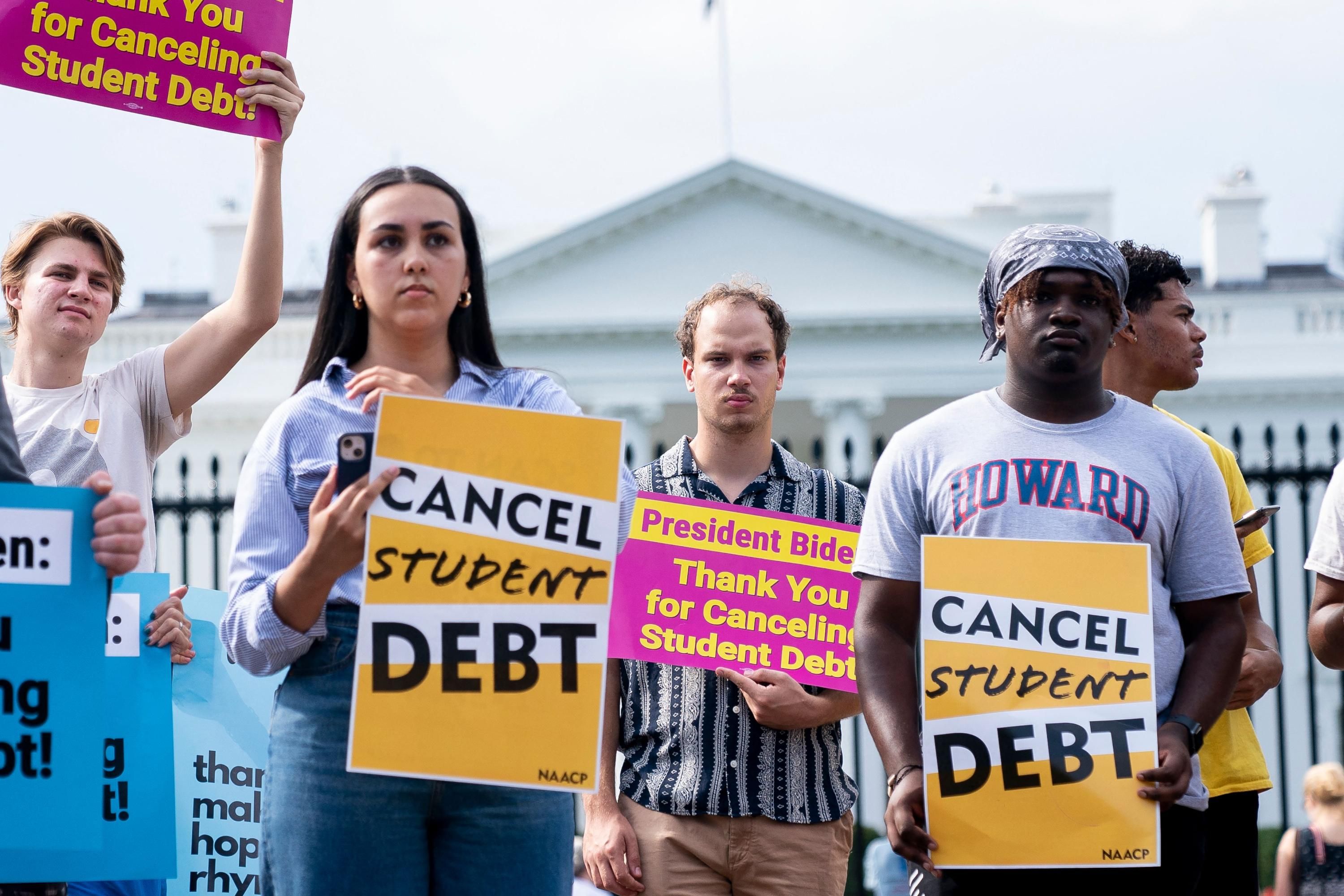 People rally in support of student debt cancellation outside of the White House