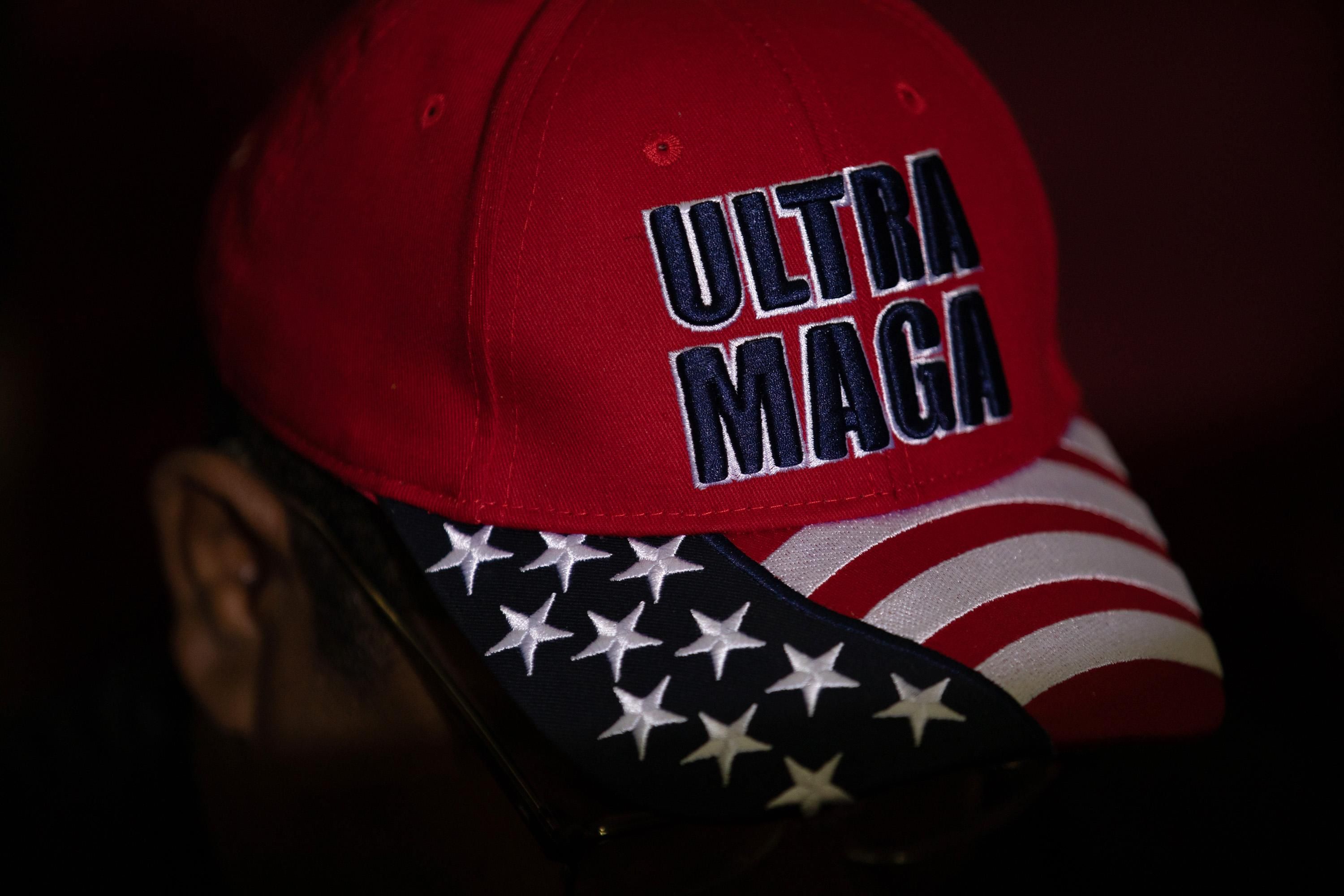 Trump supporter with a hat that reads "Ultra MAGA"