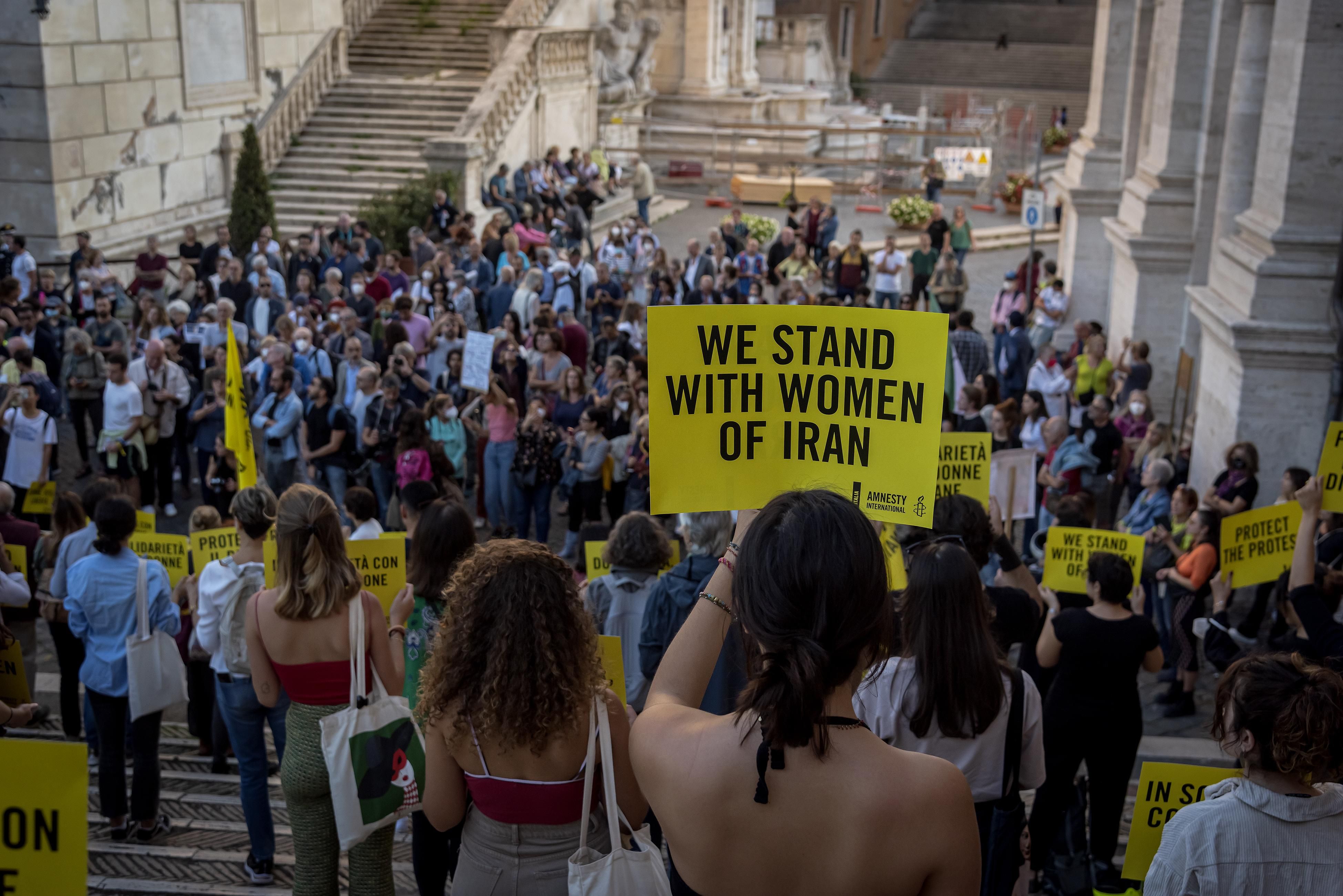 Demonstrators in Italy with signs that say "We Stand With Women of Iran"