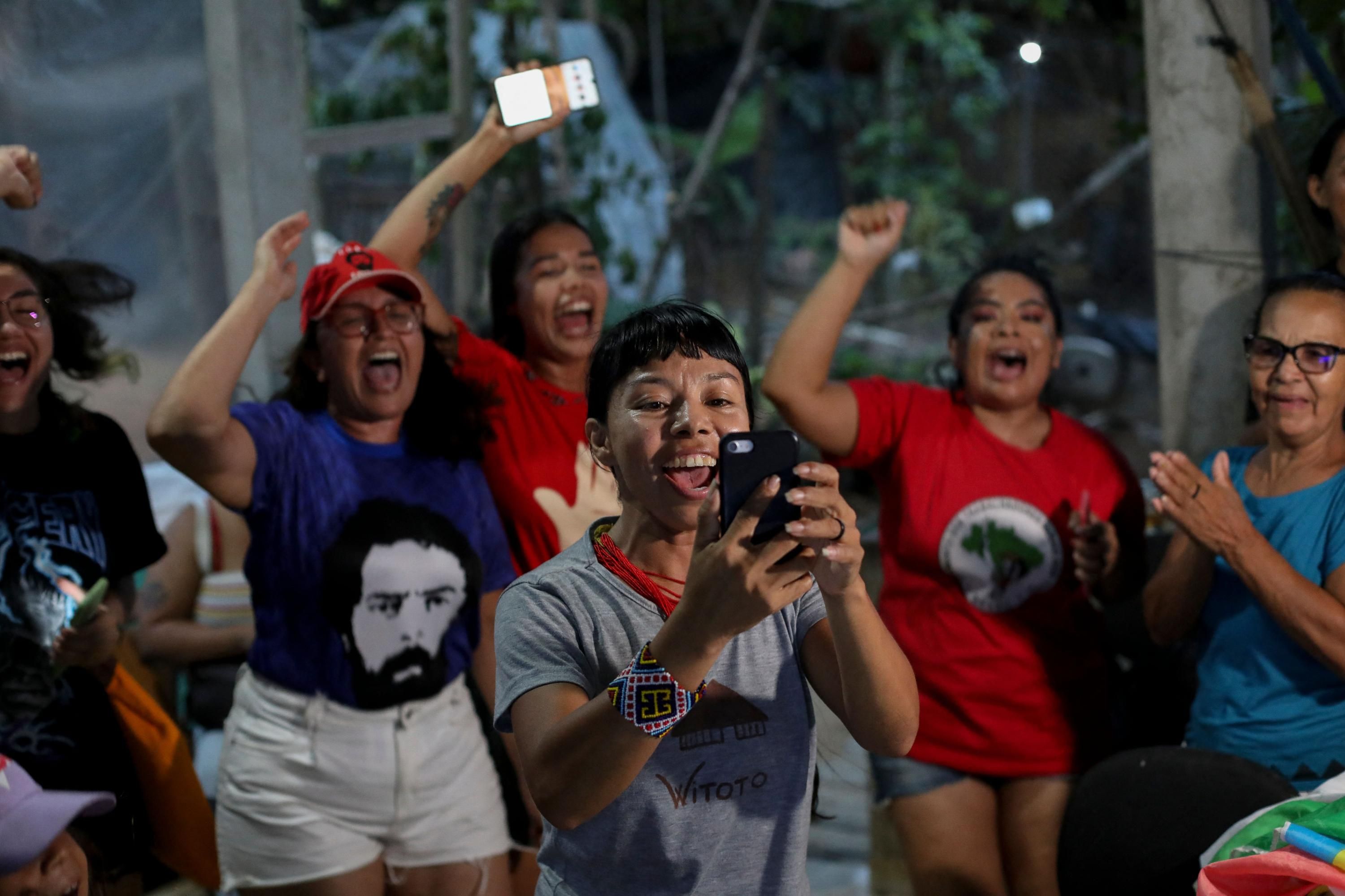 An Indigenous activist celebrates the victory of Lula