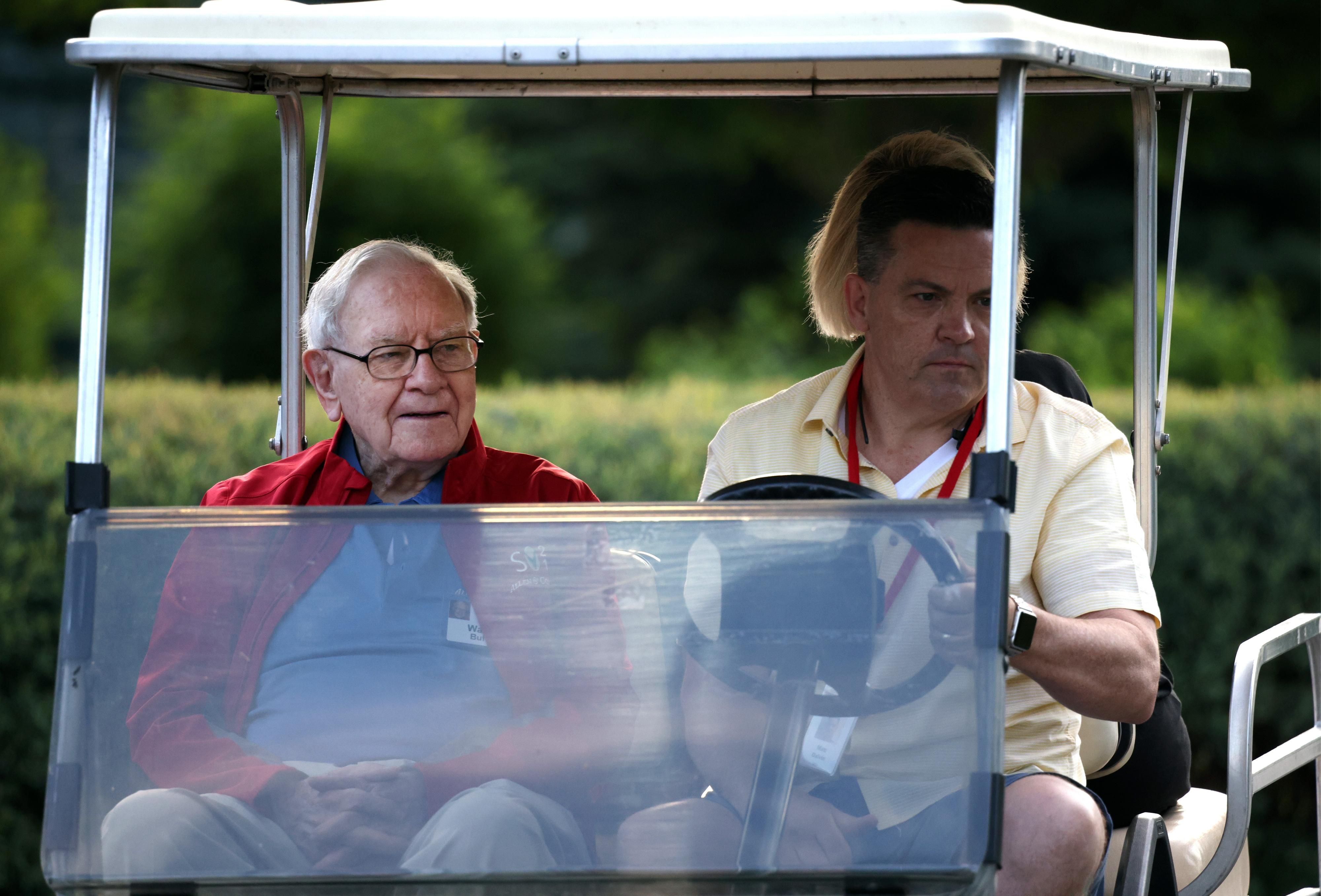 Billionaire Warren Buffett rides in a golf cart in Idaho