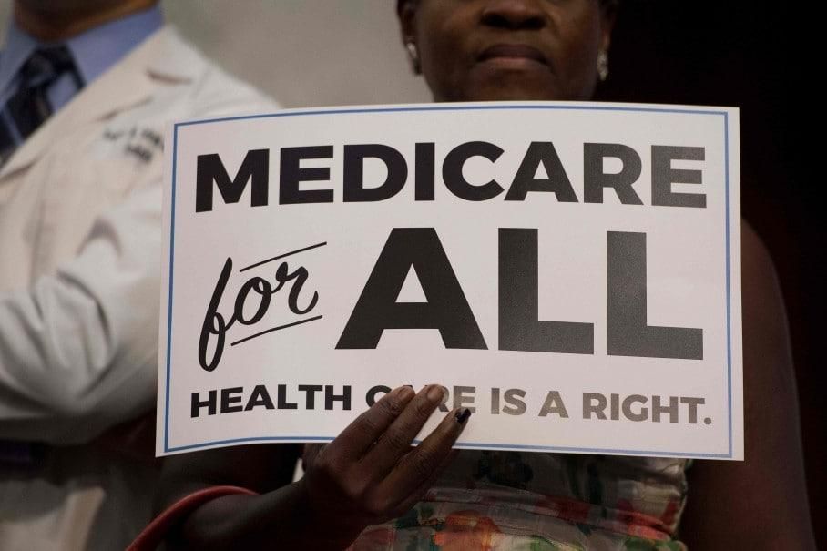 A Medicare for All supporter holds a sign on Capitol Hill. 